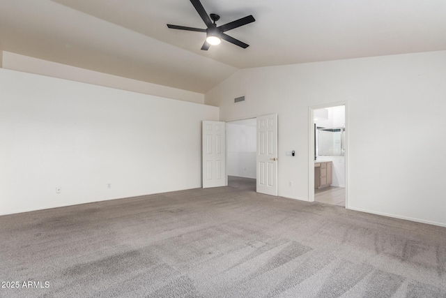 unfurnished bedroom with visible vents, light carpet, ensuite bathroom, ceiling fan, and vaulted ceiling