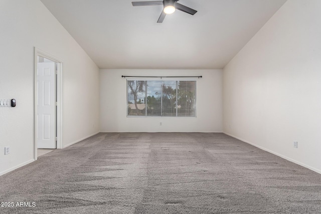 empty room with baseboards, lofted ceiling, carpet floors, and a ceiling fan