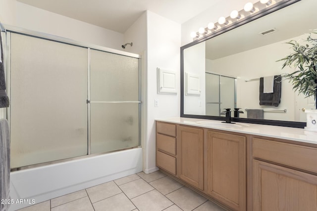 full bathroom featuring tile patterned floors, visible vents, enclosed tub / shower combo, and vanity