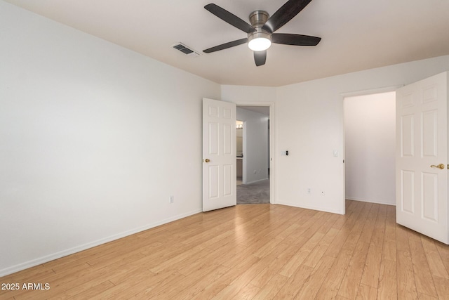 unfurnished bedroom featuring a ceiling fan, light wood-style flooring, baseboards, and visible vents