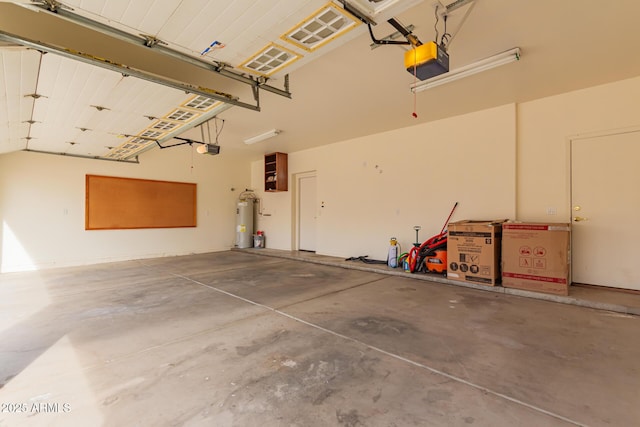 garage featuring a garage door opener and electric water heater