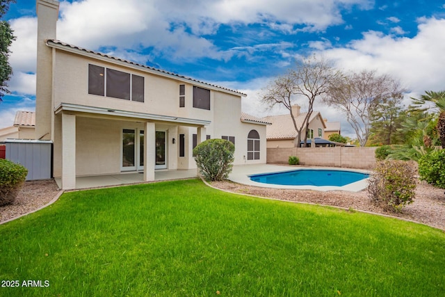 rear view of house with a patio, a fenced backyard, a lawn, and stucco siding