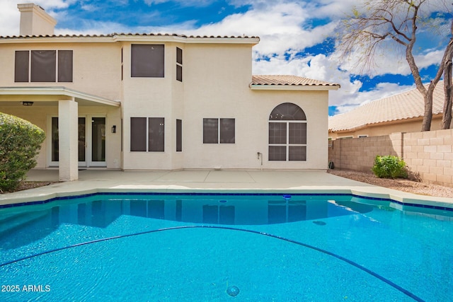 view of swimming pool with a patio area, a fenced in pool, and fence