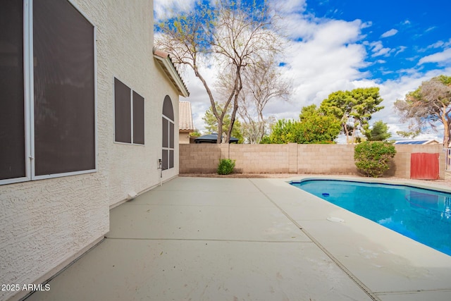 view of swimming pool with a patio area, a fenced in pool, and a fenced backyard