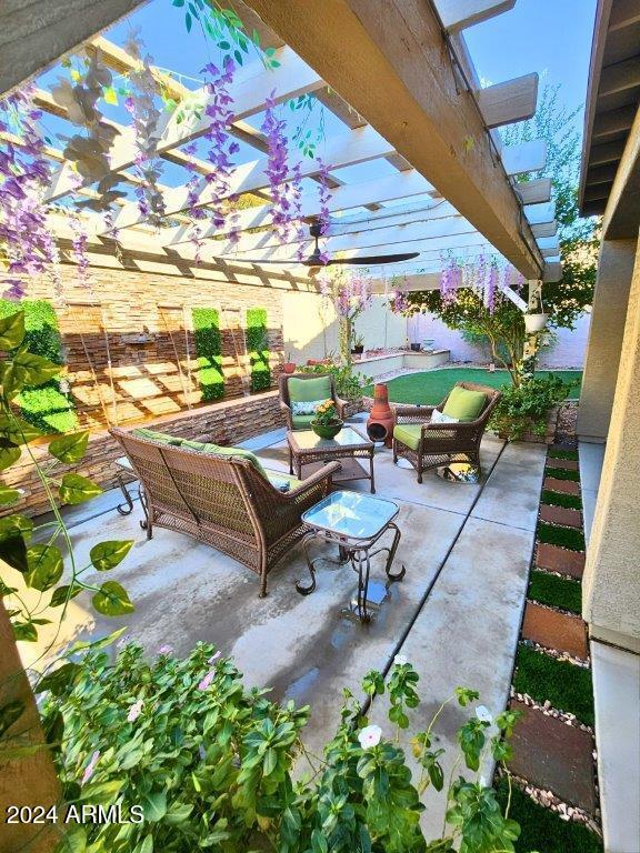 view of patio with an outdoor living space and a pergola