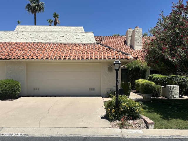7114 E Buena Terra Way, Paradise Valley, AZ 85253 - mediterranean / spanish-style house featuring a chimney, driveway, a garage, and a tile roof