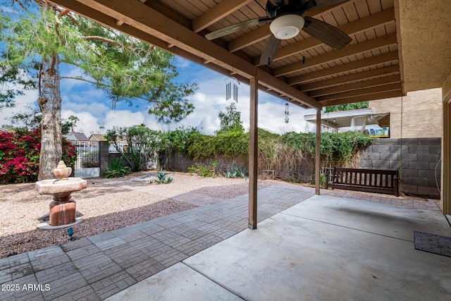 view of patio featuring a gate, fence private yard, and ceiling fan