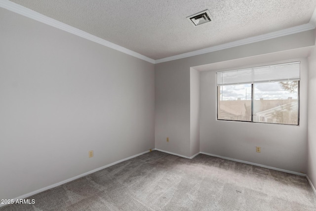 unfurnished room featuring visible vents, ornamental molding, a textured ceiling, carpet flooring, and baseboards