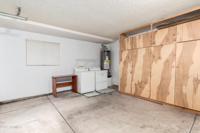 garage featuring gas water heater and separate washer and dryer