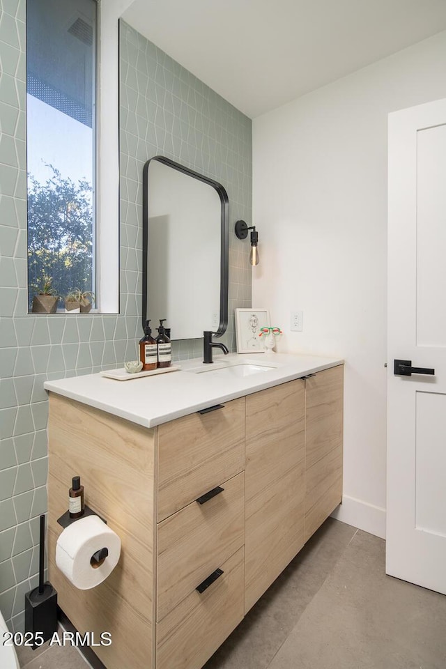 bathroom with vanity and tile walls