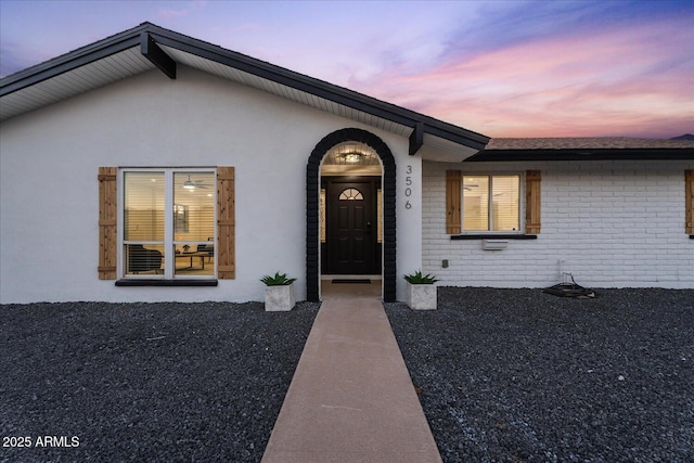 3506 W Yucca St, Phoenix, AZ 85029 - exterior entry at dusk featuring brick siding