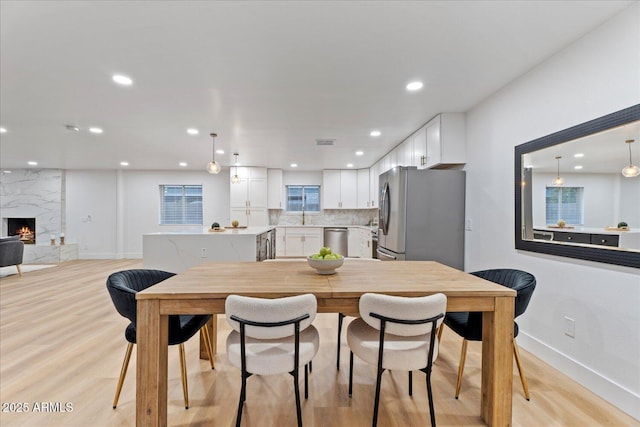 3506 W Yucca St, Phoenix, AZ 85029 - dining room featuring light wood-type flooring, recessed lighting, and a fireplace