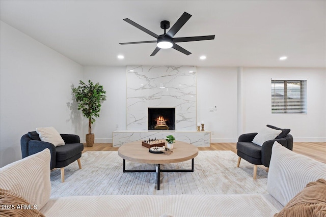 3506 W Yucca St, Phoenix, AZ 85029 - living room featuring a premium fireplace, ceiling fan, wood finished floors, and recessed lighting
