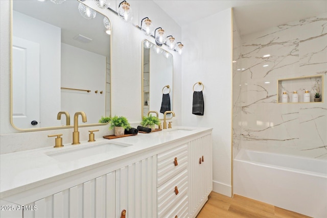 3506 W Yucca St, Phoenix, AZ 85029 - full bathroom featuring wood finished floors, double vanity, and washtub / shower combination