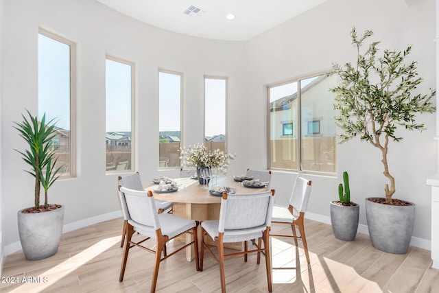 dining room with light hardwood / wood-style flooring and a wealth of natural light