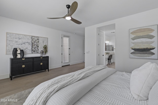 bedroom with ensuite bathroom, ceiling fan, and hardwood / wood-style flooring