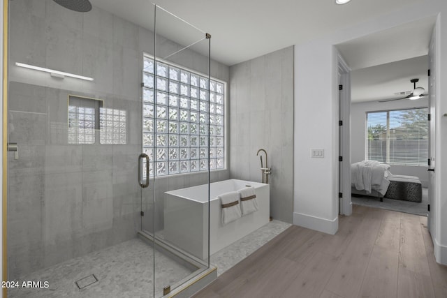 bathroom featuring ceiling fan, wood-type flooring, and independent shower and bath