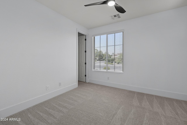 unfurnished room featuring light carpet and ceiling fan