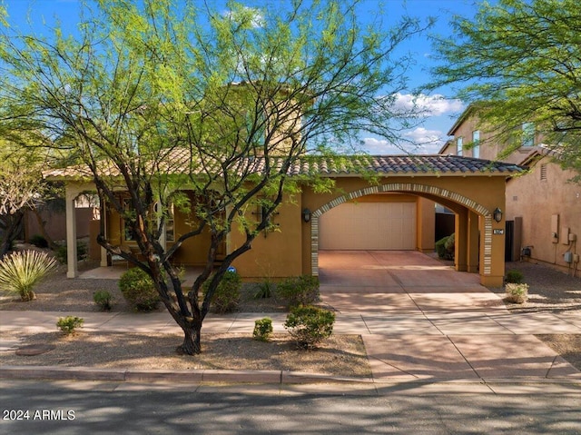 mediterranean / spanish-style home with a garage