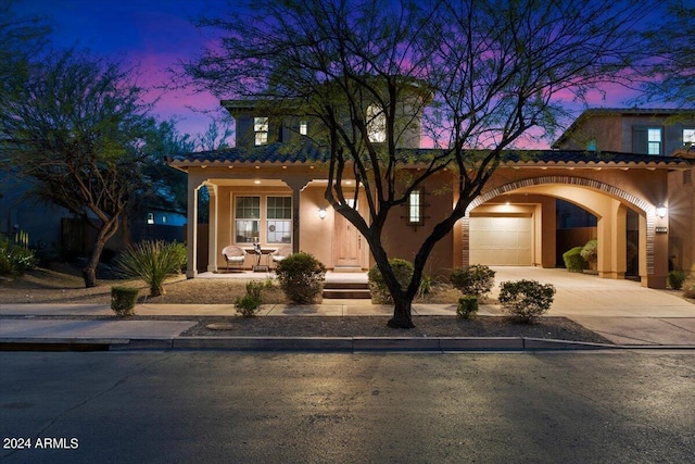 mediterranean / spanish-style house with a garage