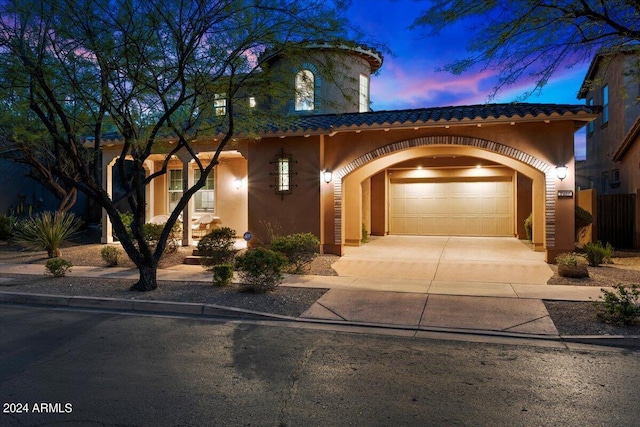 mediterranean / spanish house featuring a garage