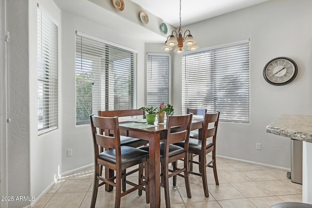 dining room featuring light tile patterned flooring and a notable chandelier