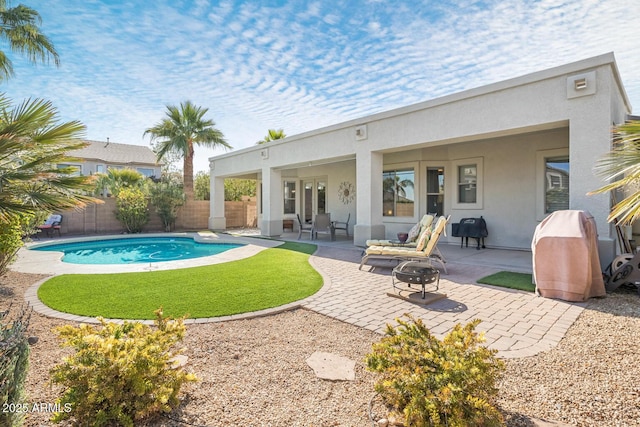 view of swimming pool with a fire pit and a patio area