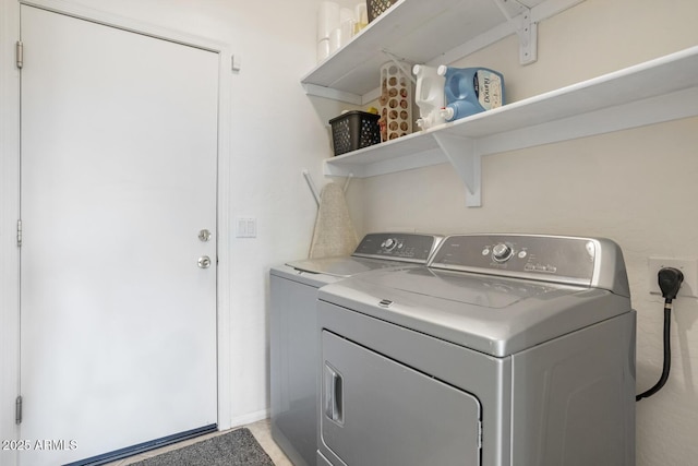 washroom with washing machine and clothes dryer