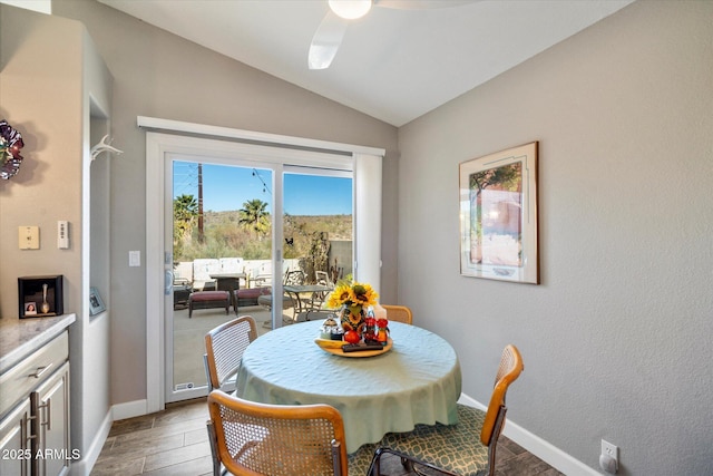 dining space featuring lofted ceiling, light wood-style floors, baseboards, and a ceiling fan