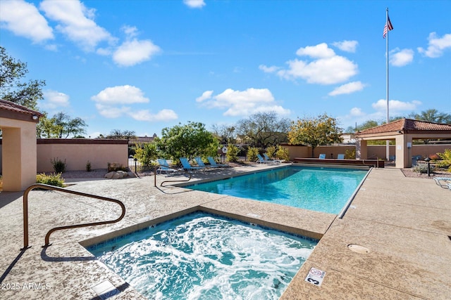 pool with fence, a community hot tub, a patio, and a gazebo