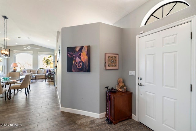 entryway with lofted ceiling, an inviting chandelier, baseboards, and dark wood finished floors