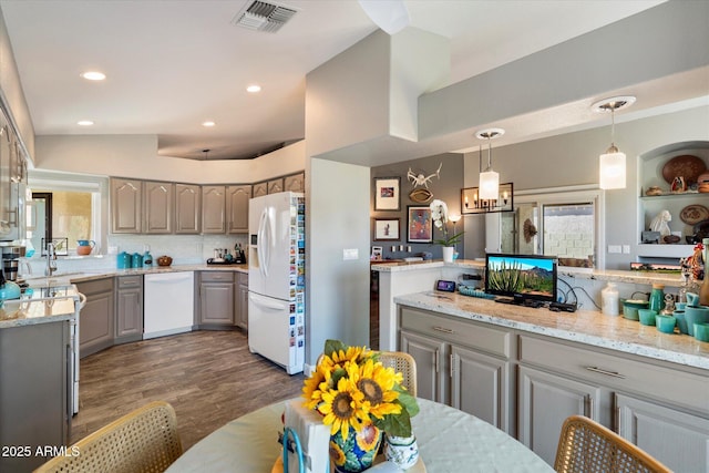 kitchen featuring recessed lighting, visible vents, gray cabinetry, wood finished floors, and white appliances