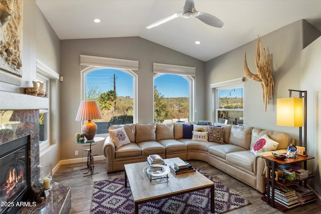 living room with lofted ceiling, ceiling fan, recessed lighting, wood finished floors, and baseboards