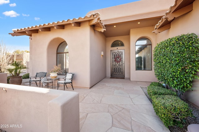 doorway to property with a patio