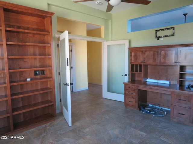 unfurnished office featuring a ceiling fan