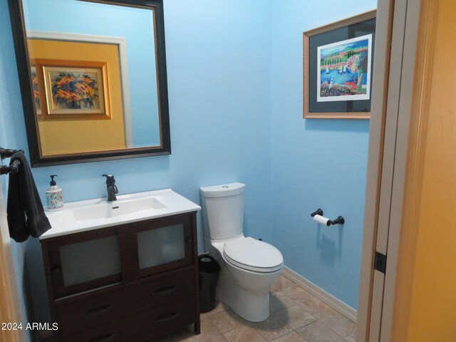 bathroom featuring vanity, toilet, and tile patterned flooring