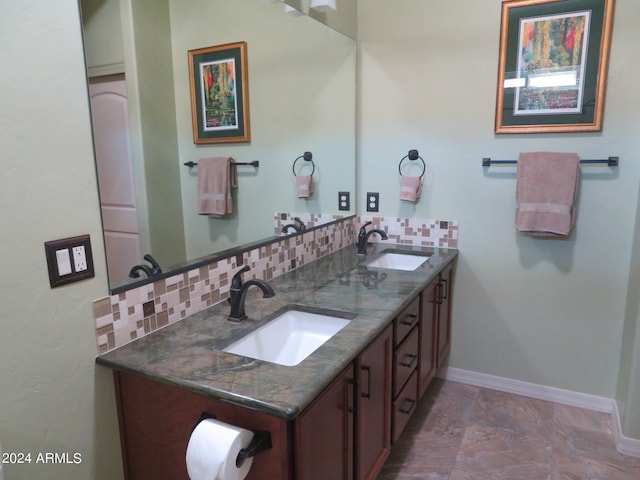 bathroom with vanity and tasteful backsplash