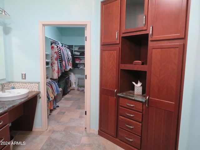 spacious closet featuring sink