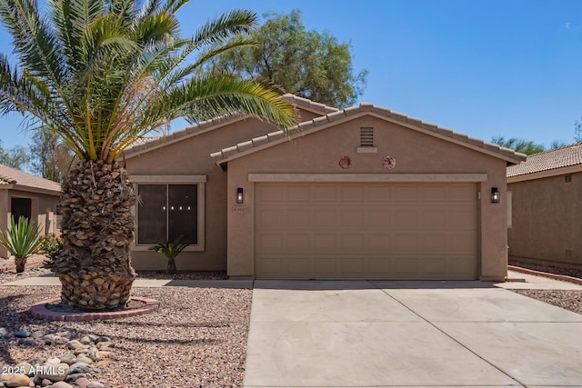 43949 W Sagebrush Trl, Maricopa, AZ 85138 - view of front of home with stucco siding, a garage, concrete driveway, and a tiled roof