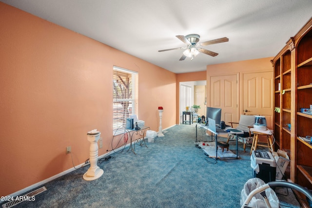 home office with ceiling fan and carpet flooring