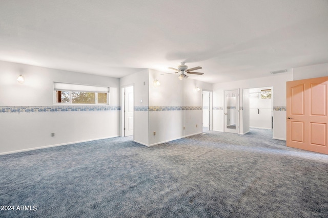1120 N Rd 1 E, Chino Valley, AZ 86323 - unfurnished living room featuring carpet flooring, a ceiling fan, and baseboards