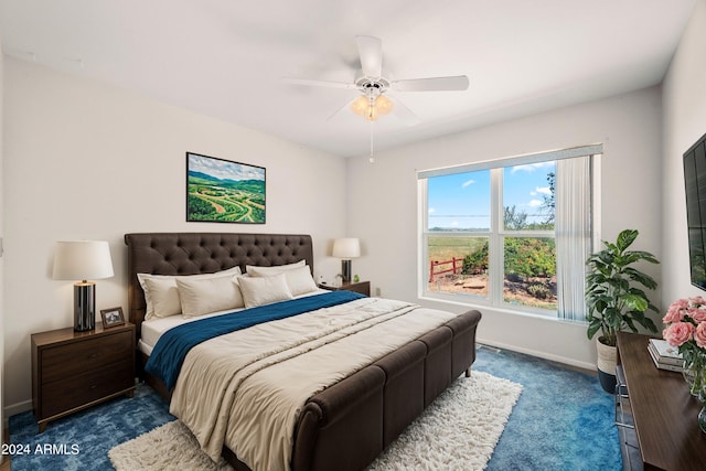 bedroom featuring dark colored carpet and ceiling fan