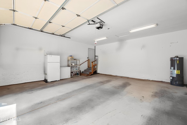 1120 N Rd 1 E, Chino Valley, AZ 86323 - garage featuring freestanding refrigerator, gas water heater, and a garage door opener