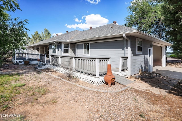 back of property featuring a wooden deck