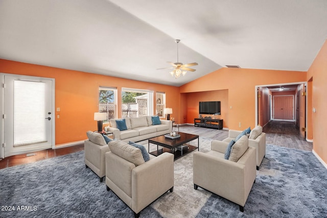 living room with ceiling fan, vaulted ceiling, and dark hardwood / wood-style flooring