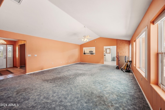 unfurnished living room with lofted ceiling, ceiling fan, and carpet floors