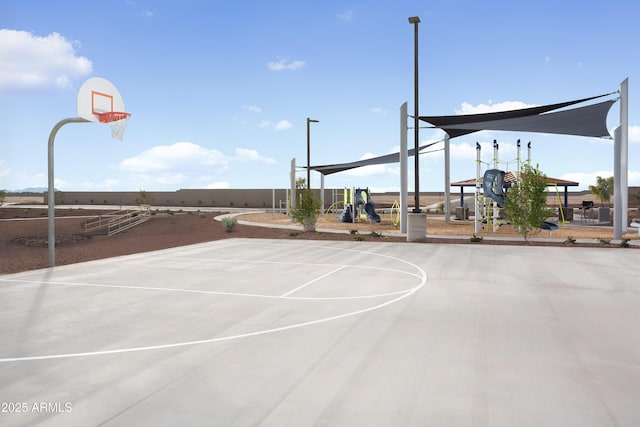 view of basketball court featuring a playground