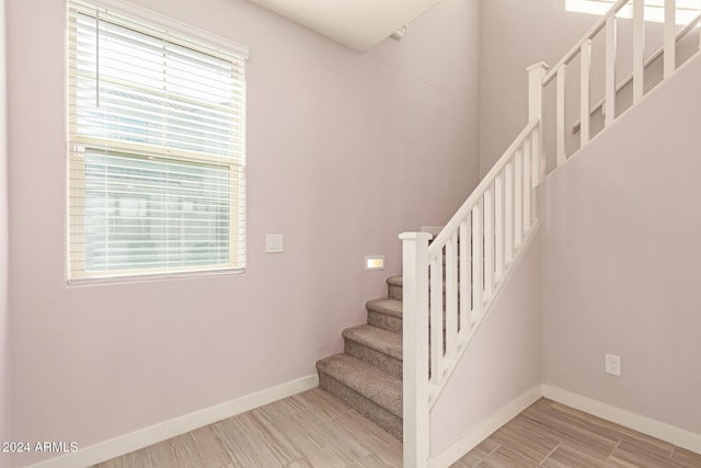 stairs featuring hardwood / wood-style flooring