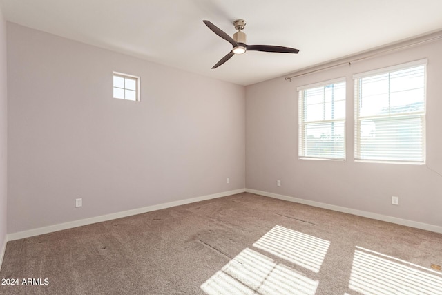 unfurnished room featuring light colored carpet and ceiling fan