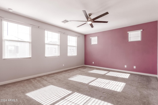 carpeted empty room featuring ceiling fan